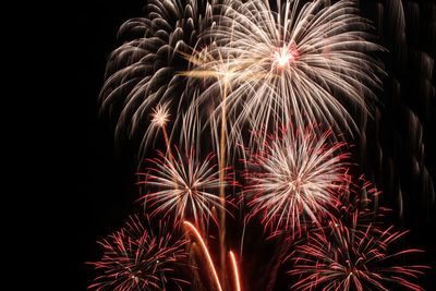 Low angle view of firework display at night