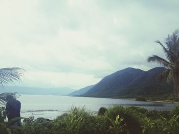 Scenic view of lake against cloudy sky