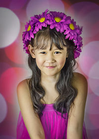 Portrait of a smiling girl with pink flower