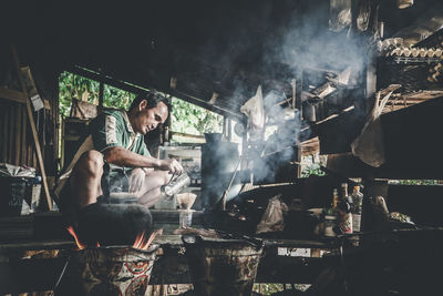 Man making coffee in shop