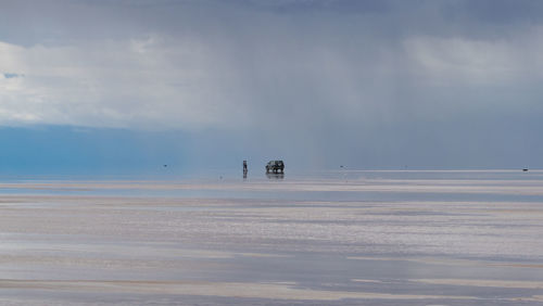 Scenic view of salt lake against sky during rain season