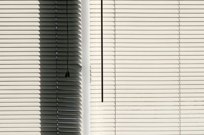 Interior view of adjustable window curtain with sunshine from outside