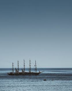 Ship sailing in sea against clear sky