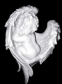 Close-up of statue against black background