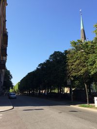 Road against clear blue sky