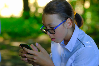 Midsection of man using mobile phone outdoors