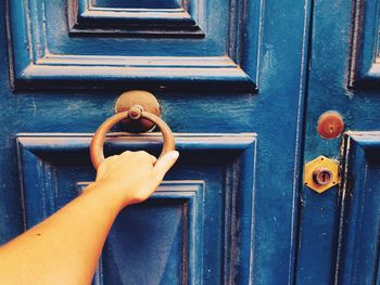 Cropped hand of woman knocking door