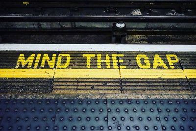 High angle view of yellow text on railroad station