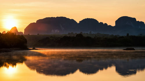 Limestone mountains and motion fog or mist over lake in sunrise, nong thale, krabi, thailand. 