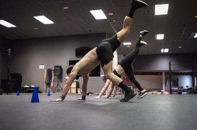 Male athletes exercising in gym