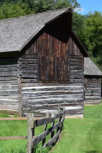 Old barn on field against building