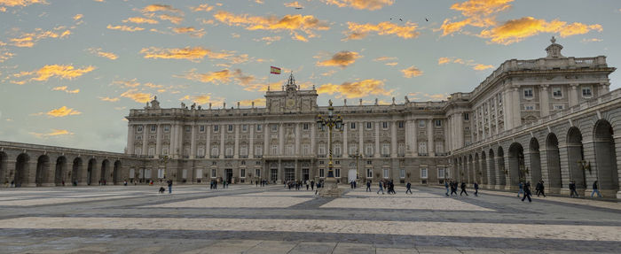Buildings in city against cloudy sky