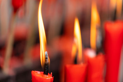 Close-up of lit candles in temple