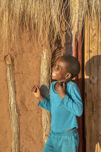 Portrait of a smiling girl standing on wood