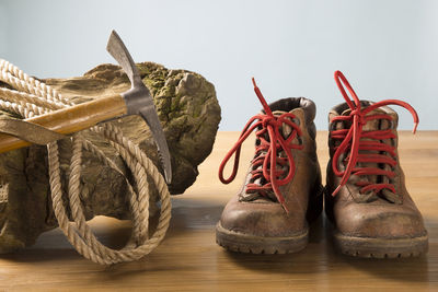 Close-up of climbing equipment and shoe on table