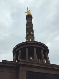 Low angle view of statue of liberty against sky