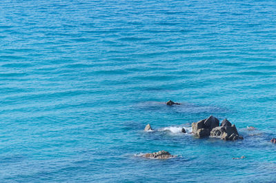 View of sharp rocks in the blue sea water