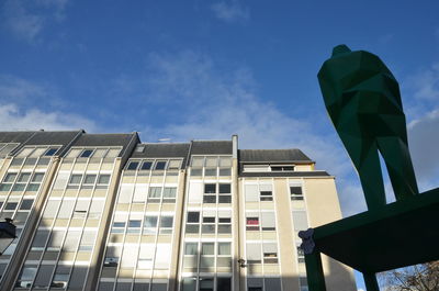 Low angle view of modern building against blue sky