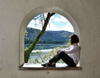 Woman sitting by window