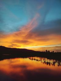 Scenic view of lake against romantic sky at sunset