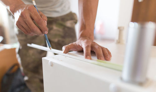 Close-up of man working on wood