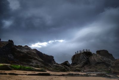 Scenic view of mountains against cloudy sky