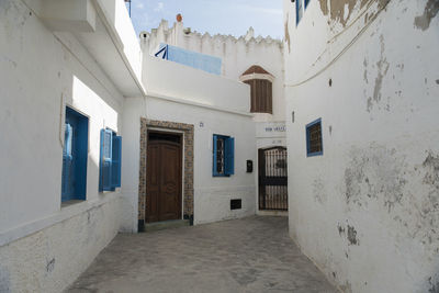 Empty alley amidst buildings in city