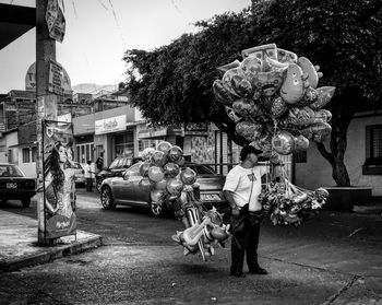 Man with umbrella on street in city