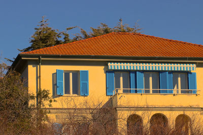 Low angle view of building against clear blue sky