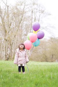 Cute girl holding balloons