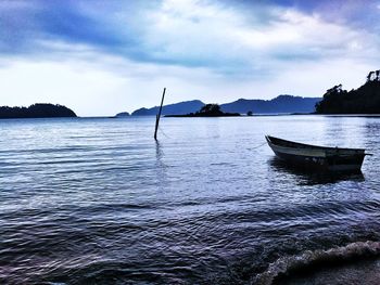 Sailboat in sea against sky