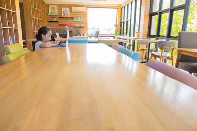 Boy sitting on table at home