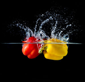 Close-up of berries on water against black background