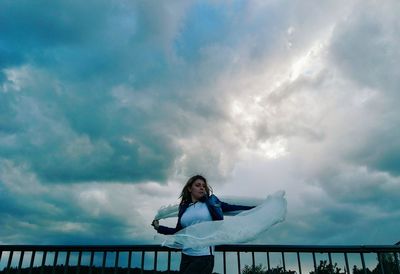 Low angle view of woman against sky