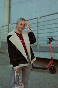 Portrait of young woman standing outdoors