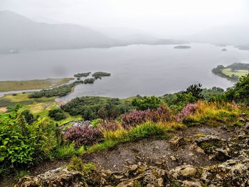 Scenic view of lake and mountains against sky