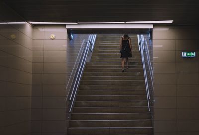 Rear view of woman walking on subway station