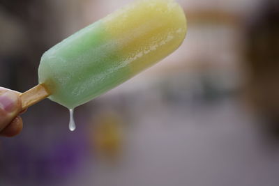 Close-up of hand holding ice cream