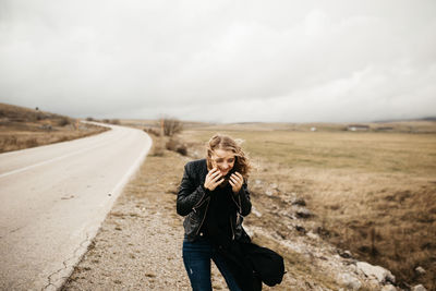 Full length of woman photographing on land