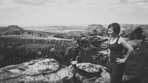 Woman standing on rock looking at view