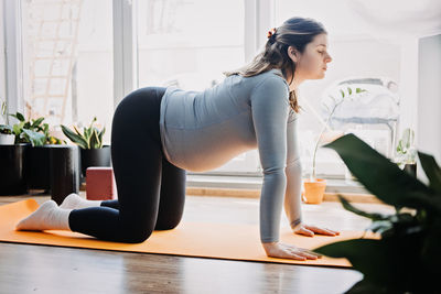 Side view of woman sitting on table