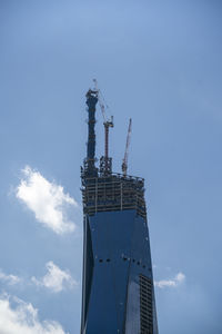 Low angle view of crane against sky