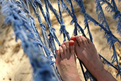 Low section of woman relaxing on hammock