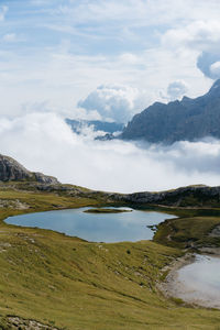 Scenic view of lake and mountains against sky