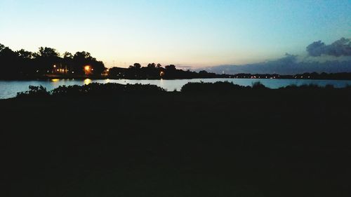 Scenic view of river against sky at sunset