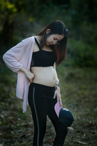 Pregnant woman standing on field