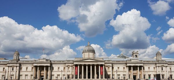 Low angle view of building against cloudy sky