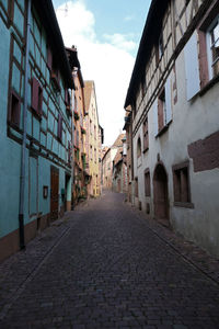 Empty alley amidst buildings in town