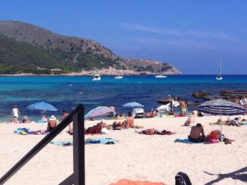 People on beach against sky
