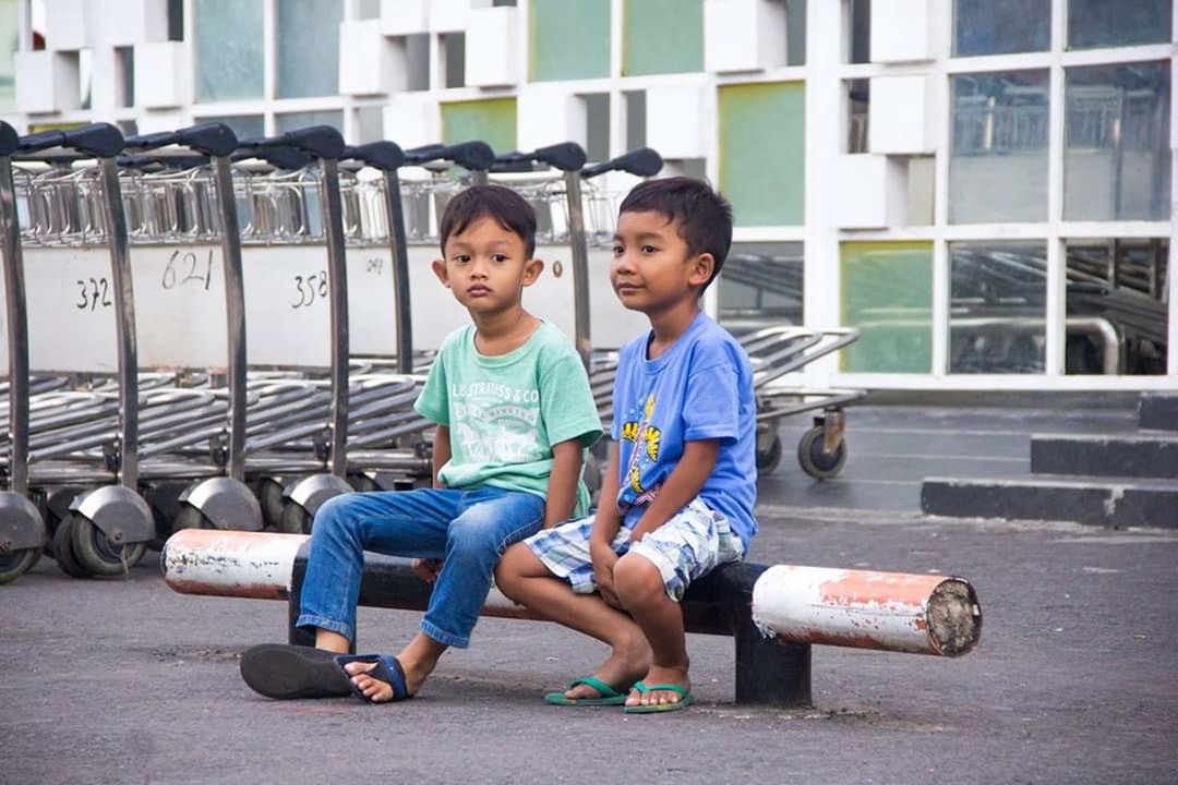 child, childhood, full length, sitting, boys, real people, males, front view, day, casual clothing, men, girls, females, two people, women, people, togetherness, leisure activity, innocence, outdoors, sister